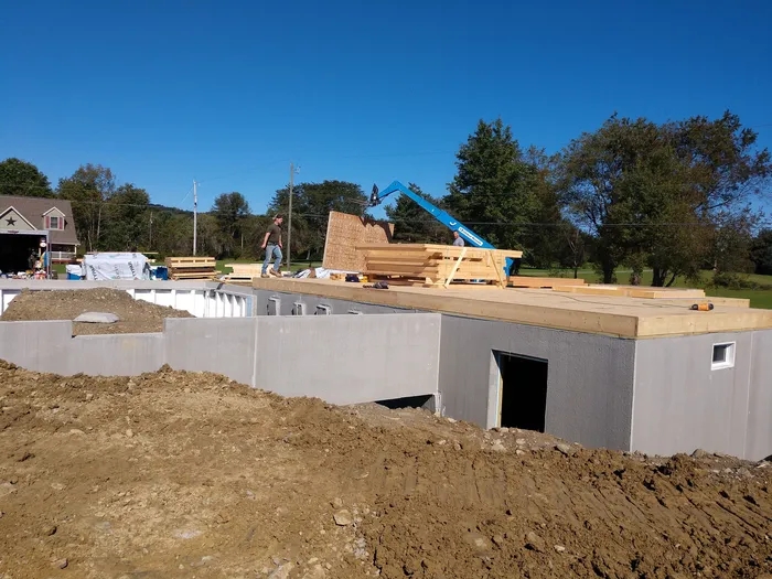 Excavator digging a foundation trench on a Southern Tier NY building site